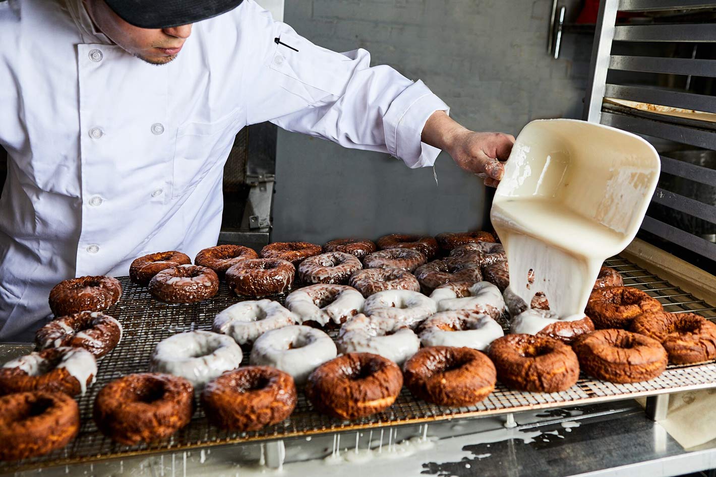 Pouring glaze on donuts